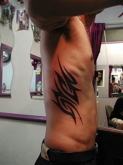 side tattoo male|tribal rib tattoos for men.